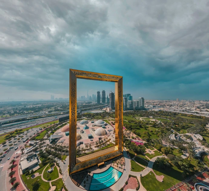 The Dubai Frame standing in a park with the city skyline in Dubai